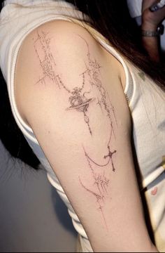 a woman with a cross tattoo on her arm