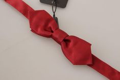 DOLCE & GABBANA Bow Tie Absolutely stunning, 100% Authentic, brand new with tags Dolce & Gabbana exclusive bow tie. Color: Red Model: Tied Material: 100% Silk Adjustable length neck strap, one size Made in Italy Width: 3.5cm Length: 12cm Fitted Pre-tied Bow For Party, Fitted Pre-tied Tie For Party, Elegant Red Satin Bow, Elegant Red Adjustable Bow, Elegant Pre-tied Bow For Gift, Elegant Red Bow Tie Adjustable, Elegant Fitted Ribbon Tie, Elegant Adjustable Red Bow Tie, Elegant Fitted Bow For Gift