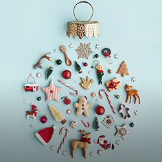 a christmas ornament hanging from the side of a blue wall with ornaments on it