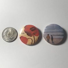 three magnets depicting two people walking on the beach, one with a penny in his hand