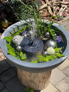 a potted planter filled with balls and plants