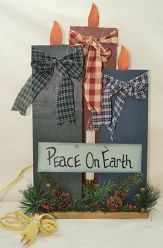 a sign that says peace on earth and two bows