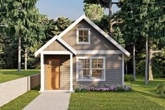 a small gray house sitting on top of a lush green field