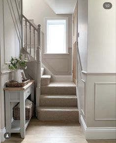 there is a hallway with stairs leading up to the second floor