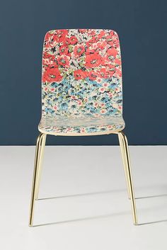 a colorful chair sitting on top of a white table