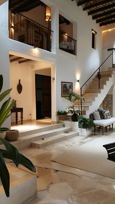 the interior of a house with white walls and stairs