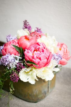 a vase filled with lots of pink and white flowers