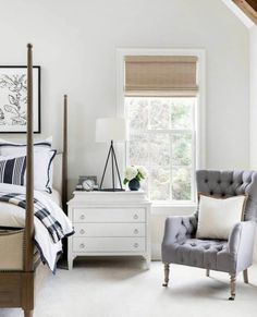 a bedroom with white walls and furniture