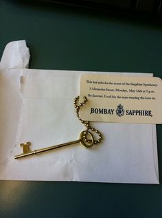 a gold key is on top of a piece of paper that says, bombay sapphire