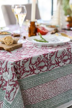 a table topped with plates and glasses of wine