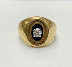 A beautiful ring with a lovely florentine texture. It centers a natural european cut diamond, approximately .20 carats, G color VS clarity in a black enamel background. It is 17mm wide with a 5mm rise, and a 3mm shank Marked 14K EVERBRITE  7g Formal Round Enamel Ring With Single Cut Diamonds, Formal Enamel Ring With Single Cut Diamonds, Classic Formal Enamel Round Ring, Classic Formal Enamel Ring, Classic Diamond Enamel Ring For Formal Occasions, Classic Formal Enamel Diamond Ring, Gold Enamel Ring With Diamond Accents For Formal Occasions, Classic Yellow Gold Enamel Ring For Formal Occasions, Formal Gold Diamond Ring With Black Enamel