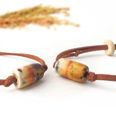 This unique, elegant hand crafted  ceramic bracelet made from stoneware clay and painted by hand with colorful mediterranean motifs.  Our ceramic bracelets are strung on an adjustable cotton cord and feature a single wooden or metal bead and it's perfectly adjustable as you wish. Dimensions 0.9 oz 6" min L - x 9" max L Each ceramic bracelet comes out of the kiln with slight differences, so when you order, there may be 5% differences about colors and tones of the product. Kiln fired to extremely high heat to add strength and durability. Adjustable Hand Painted Jewelry For Everyday, Artisan Bracelet With Sliding Knot For Gift, Artisan Bracelet With Sliding Knot As Gift, Adjustable Hand Painted Bracelets For Gift, Rustic Hand-tooled Adjustable Leather Bracelet, Adjustable Hand-tooled Brown Leather Bracelet, Spiritual Brown Leather Bracelet Hand-strung, Ceramic Bracelet, Bracelets Unique