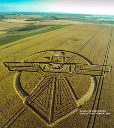 an aerial view of a crop circle in the middle of a field with words on it