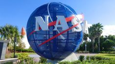 nasa sign in front of palm trees and blue sky