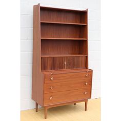 a wooden bookcase with two drawers on it