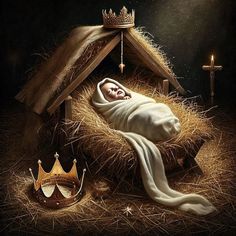 a nativity scene with a baby jesus in the manger, crown and candles