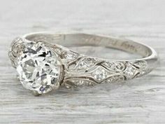 an antique style diamond ring with filigrees