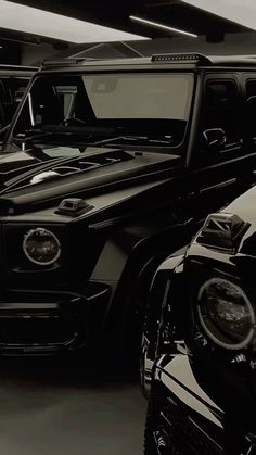 two black and white cars parked in a garage