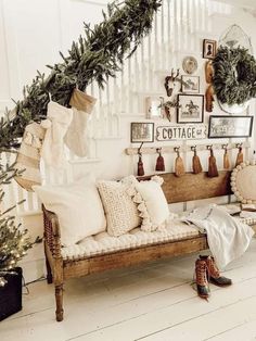 a living room filled with lots of furniture and christmas wreaths on the wall above it