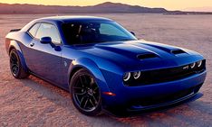 a blue sports car parked in the desert