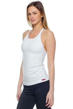 Elevate your basics with the Hard Tail Double Cross Tank. Featuring a White hue, with a high cut neckline, and a double cross design in back, this tank boasts chic style and freedom of movement. Made of a soft, flexible cotton/lycra blend fabric, with a built-in shelf bra, this tank offers comfortable style for in and out of the studio. Wear this tank for yoga, barre, gym sessions, or for everyday style.     Get the Deets:    High cut neckline, for full coverage.  Semi-fitted.  Pre-shr Cotton Tank Top With Built-in Bra For Gym, High Stretch Tops With Built-in Bra And Cross Back, White Stretch Halter Neck Tank Top, Casual Cross Back Tank Top With Built-in Bra, White T-back Top With Built-in Bra, Stretch T-back Tops For Workout, White Stretch Halter Tank Top, White Fitted Cross Back Top, Fitted Cross Back Tank Top With Built-in Bra