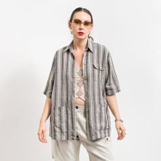 Vintage linen loose fit short sleeve blouse in cream-gray stripes - 3 pockets - fastened with wooden buttons - materials: 100% linen Size from the label: 40 best fits women: L/XL MEASUREMENTS bust: 48 inches (122 cm) length: 30 inches (76 cm) The model is 5'9" (174 cm), measures 35-27-38 (89-69-96 cm) and typically wears clothing in size M CONDITION - 9/10 - The shirt in great pre-owned condition. Washed, ready to wear Beige Tops With Vertical Stripes For Summer, Summer Blouse With Vertical Stripes And Relaxed Fit, Striped Short Sleeve Blouse With Relaxed Fit, Striped Relaxed Fit Short Sleeve Blouse, Striped Blouse With Pockets Relaxed Fit, Oversized Striped Short Sleeve Blouse, Striped Short Sleeve Shirt With Pockets, Striped Linen Short Sleeve Top, Cotton T-shirt With Striped Collar And Relaxed Fit