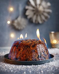 a bundt cake with lit candles sitting on top of it