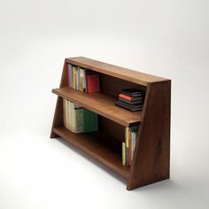 a wooden shelf with books on it and some other items in the bottom half of it