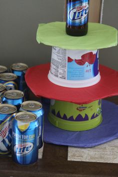 a cake made to look like a top hat with soda cans on it and an empty beer can