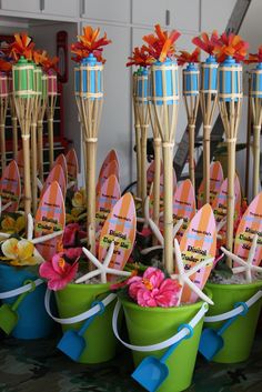 there are many small buckets that have surfboards in them and flowers on them