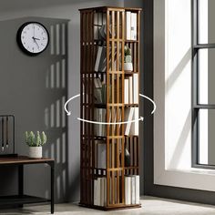 a tall wooden bookcase with many books on it in front of a large window