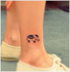 a small elephant tattoo on the foot of a woman's right leg and ankle