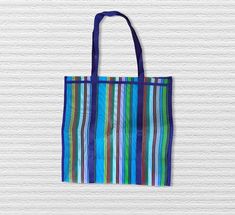 Use this bag for the beach, as a gift bag for parties, or even as a summer purse to make your look stand out. This is a perfect beach for groceries, since it can fit a lot and the handles are strong enough to carry weight.  The bags measure 19 x 19 inches without the handle (with handle is 30 x 19 inches) and made out of a sturdy fabric commonly seen in travel bags. The bag is 9 inches wide fully extended.  We are Mexican Designers and love to share our culture. This market bag is representative Multicolor Summer Bags For Gifts, Multicolor Summer Bags Suitable For Gifts, Summer Style Multicolor Bags For Gifts, Blue Recyclable Beach Bag For Summer, Multicolor Reusable Summer Bags, Blue Reusable Tote Beach Bag, Reusable Multicolor Summer Beach Bag, Multicolor Reusable Beach Bag For Summer, Multicolor Recyclable Beach Bag For Vacation