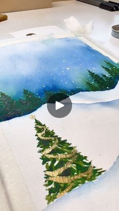 an image of a painting being made with watercolors and paper on a table