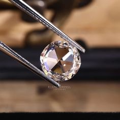 an image of a diamond being held by two tongs in front of the camera