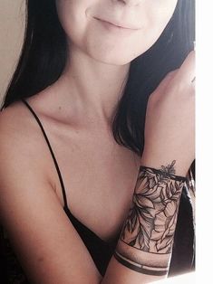 a woman with a tattoo on her arm