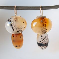 Elegant and earthy, hand-cut Montana agate makes these one-of-a-kind earrings truly special. The glossy and translucent gems hang from solid 14k recycled gold hooks. Made by hand to be heirloom-quality by S. Yamane Studio. Stone: Hand Cut Light Montana AgateMetal: 14k Recycled Yellow Gold Measurements: 35mm top of earwire to bottom, 17.75mm widest pointPlease note that original gemstones make each earring unique, so your stones may vary slightly from those pictured. Chain Threader Earrings, Floral Tiara, Gold Hooks, Montana Agate, Agate Earrings, Threader Earrings, Recycled Gold, Unique Earrings, Montana