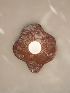 a piece of bread sitting on top of a white countertop next to a light