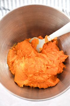 a metal bowl filled with mashed sweet potatoes