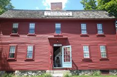 an old red house with two story windows