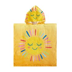 a yellow towel with a sun design on the front and back, it has eyes closed