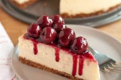 a slice of cheesecake with cherries on top