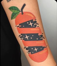 a person with a tattoo on their arm that has an orange and black design on it