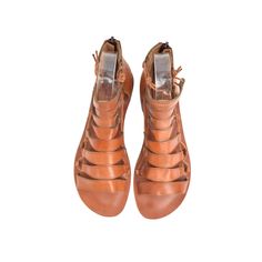 COLOR: Tan LEATHER TYPE: Vegetable Leather MATERIAL: Made from %100 leather. SOLE: Leathery IN SOLE : %100 leather. HEEL HEIGHT: 1.5 cm DESIGN: Lace-up & Zippered GENDER: Women's The FIBO Hera Tan Leather Sandal is expertly crafted with %100 leather, a zipper back closure, and an ergonomic heel design for comfort. These shoes are handcrafted and expertly stitched by skilled artisans for a unique pair of sandals. Brown Leather T-strap Sandals For Spring, Brown Leather T-strap Sandals With Flat Heel, Brown Leather Flat Heel T-strap Sandals, Brown Leather T-strap Sandals With Leather Footbed, Leather Woven Ankle Strap Huarache Sandals, Leather Huarache Sandals With Removable Insole And Ankle Strap, Leather Huarache Sandals With Flat Heel, Leather Woven Huarache Sandals With Ankle Strap, Brown Leather T-strap Sandals With Buckle