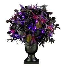 a vase filled with purple flowers on top of a table