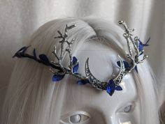 A gorgeous sapphire woodland tiara featuring a silver moon and branches on either side. Your eyes will follow the deep blue leaves surrounding the piece and onto the sparkling sapphire crystal in the center. Choose between silver charms as pictured or bronze! Silver Sapphire Tiara, Blue Crown Aesthetic, Sapphire Headpiece, Blue Sapphire Aesthetic, Blue And Silver Aesthetic, Blue Jewelry Aesthetic, Sapphire Aesthetic, Sapphire Accessories, Kitsune Boy