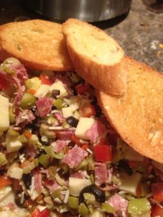 a close up of a plate of food with bread and vegetables on it's side