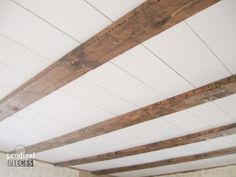 an unfinished wooden ceiling with white paint and wood slats