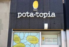 there is a sign that says potato topia on the building