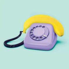 an old fashioned phone with a banana on the front and bottom receiver, sitting on a blue background